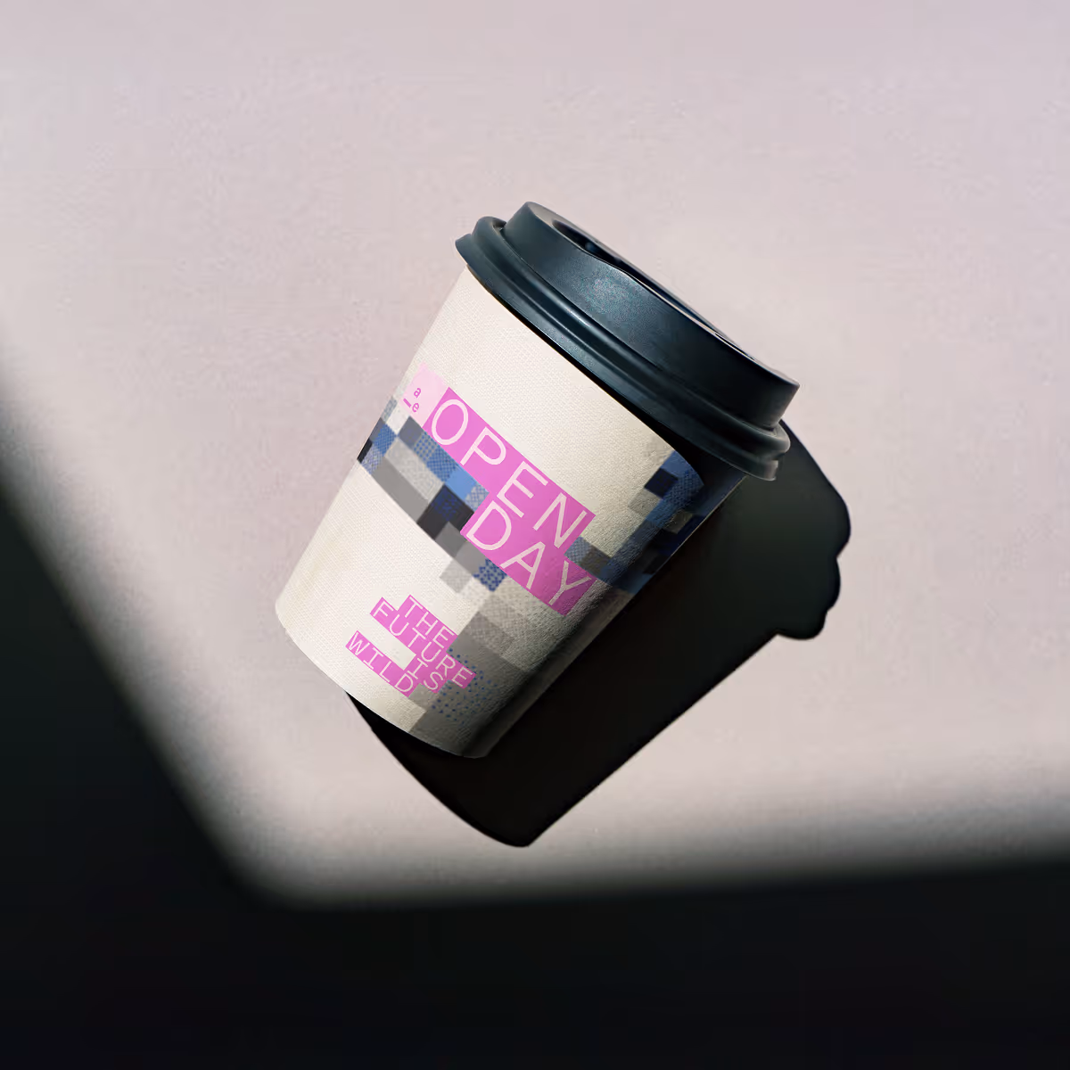 Takeaway coffee cup with black lid and label reading Open Day in pink on light background.